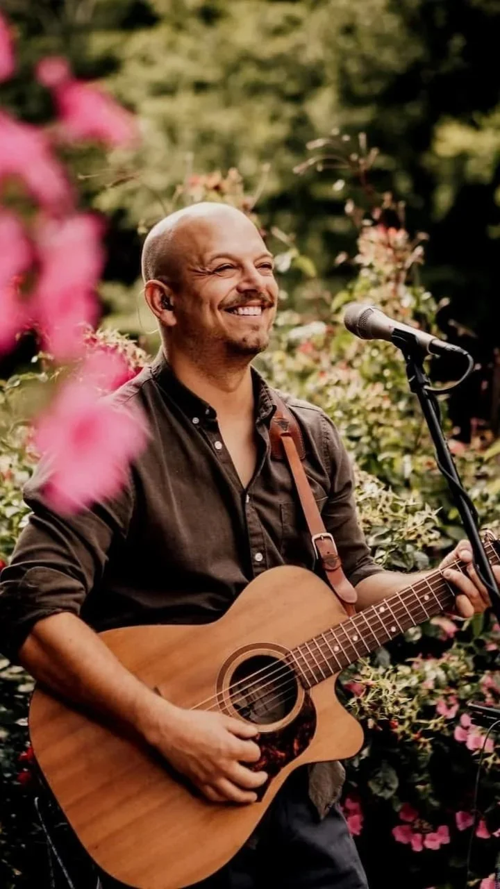 Tristan Mackay performing acoustic music at a wedding